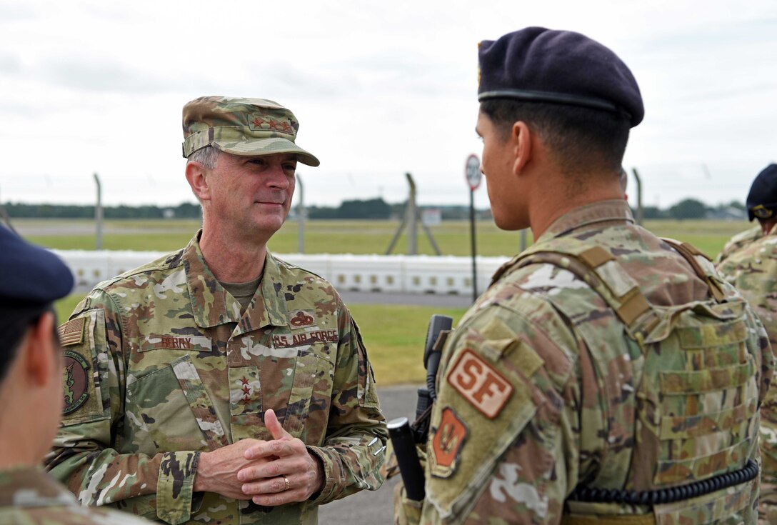 Lt. Gen. Warren Berry, deputy chief of staff for Logistics, Engineering and Force Protection, receives a security briefing from Airman 1st Class Anthony Ortiz, 100th Security Forces Squadron member, during a visit to RAF Mildenhall, England, July 22, 2019. During his tour, Berry was shown upgrades to security around base, the latest innovation tools used on the flightline and received briefings on major engineering and logistic projects. (U.S. Air Force photo by Airman 1st Class Brandon Esau)