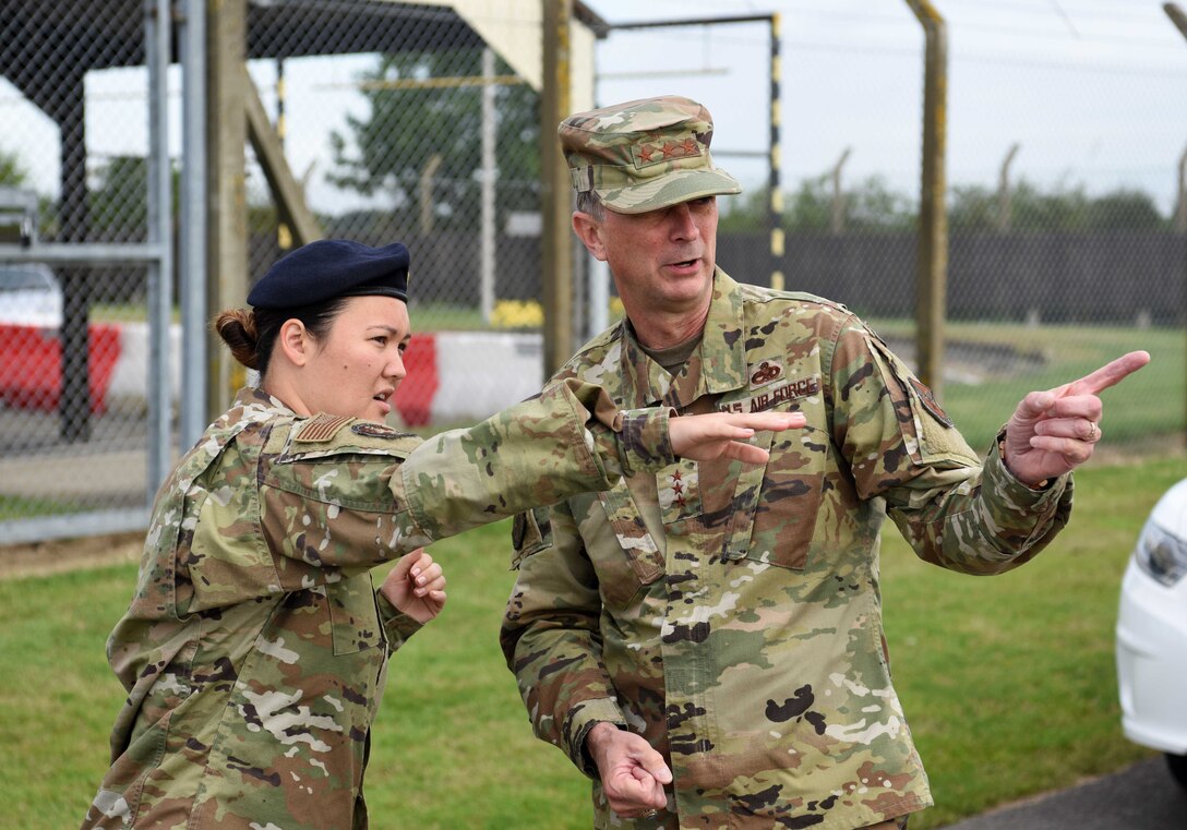 Lt. Gen. Warren Berry, deputy chief of staff for Logistics, Engineering and Force Protection, discusses security upgrades with Staff Sgt. Katherine Tedrow, 100th Security Forces Squadron member, during a visit to RAF Mildenhall, England, July 22, 2019. During his tour, Berry was shown upgrades to security around base, the latest innovation tools used on the flightline and received briefings on major engineering and logistic projects. (U.S. Air Force photo by Airman 1st Class Brandon Esau)
