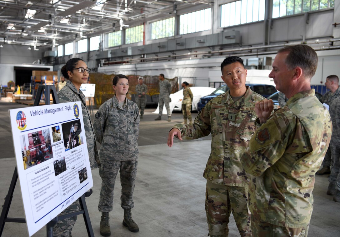 Lt. Gen. Warren Berry, deputy chief of staff for Logistics, Engineering and Force Protection, receives a vehicle management briefing from 1st Lt. Kenny Maeng, 100th Logistics Readiness Squadron flight commander, during a visit to RAF Mildenhall, England, July 22, 2019. During his visit, Berry was also shown upgrades to security around base, the latest innovation tools used on the flightline and received briefings on major engineering and logistic projects. (U.S. Air Force photo by Airman 1st Class Brandon Esau)