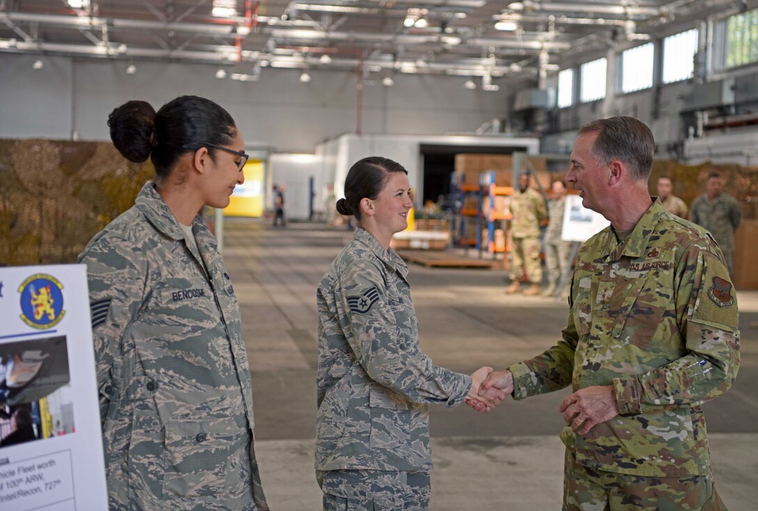 Lt. Gen. Warren Berry, deputy chief of staff for Logistics, Engineering and Force Protection, coins Staff Sgt. Garrison West, 100th Logistics Readiness Squadron fire and refueling vehicle journeyman, during a visit to RAF Mildenhall, England, July 22, 2019. During his visit, Berry was also shown upgrades to security around base, the latest innovation tools used on the flightline and received briefings on major engineering and logistic projects. (U.S. Air Force photo by Airman 1st Class Brandon Esau)