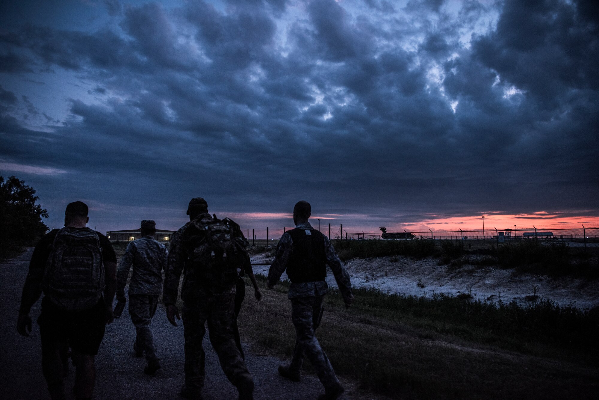 Members of Laughlin Air Force Base, Texas, ruck march for 5 kilometers on July 23, 2019. “Walk with the Chief” is a monthly opportunity to interact with Laughlin’s command chief, Chief Master Sgt. Robert Zackery III, in a fun and informal setting, and prepare Airmen for a deployed environment. (U.S. Air Force photo by Airman 1st Class Marco A. Gomez)
