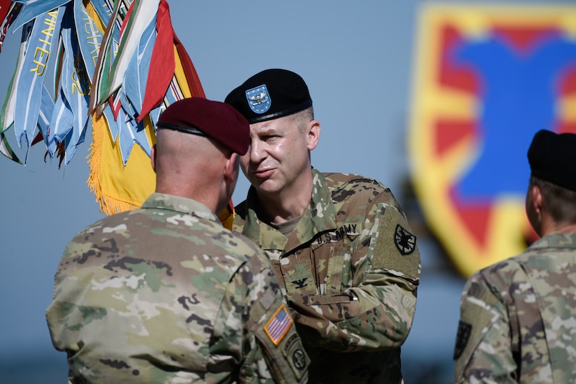 U.S. Army Col. Timothy Zetterwall, incoming 7th Transportation Brigade (Expeditionary) commander, receives the colors from Maj. Gen. Brian J. McKiernan, XVIII Airborne Corps and Fort Bragg deputy commanding general, during a change of command ceremony at Joint Base Langley-Eustis, Virginia, July 18, 2019.