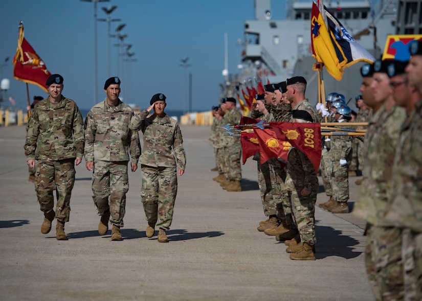 U.S. Army Col. Beth A. Behn, right, outgoing 7th Transportation Brigade (Expeditionary) commander, walks with Col. Timothy Zetterwall, left, incoming 7th TBX commander, and Lt. Col. Brian J. Slotnick, center, the ceremony’s commander of troops, and salutes Soldiers in formation during a change of command ceremony at Joint Base Langley-Eustis, Virginia, July 18, 2019.