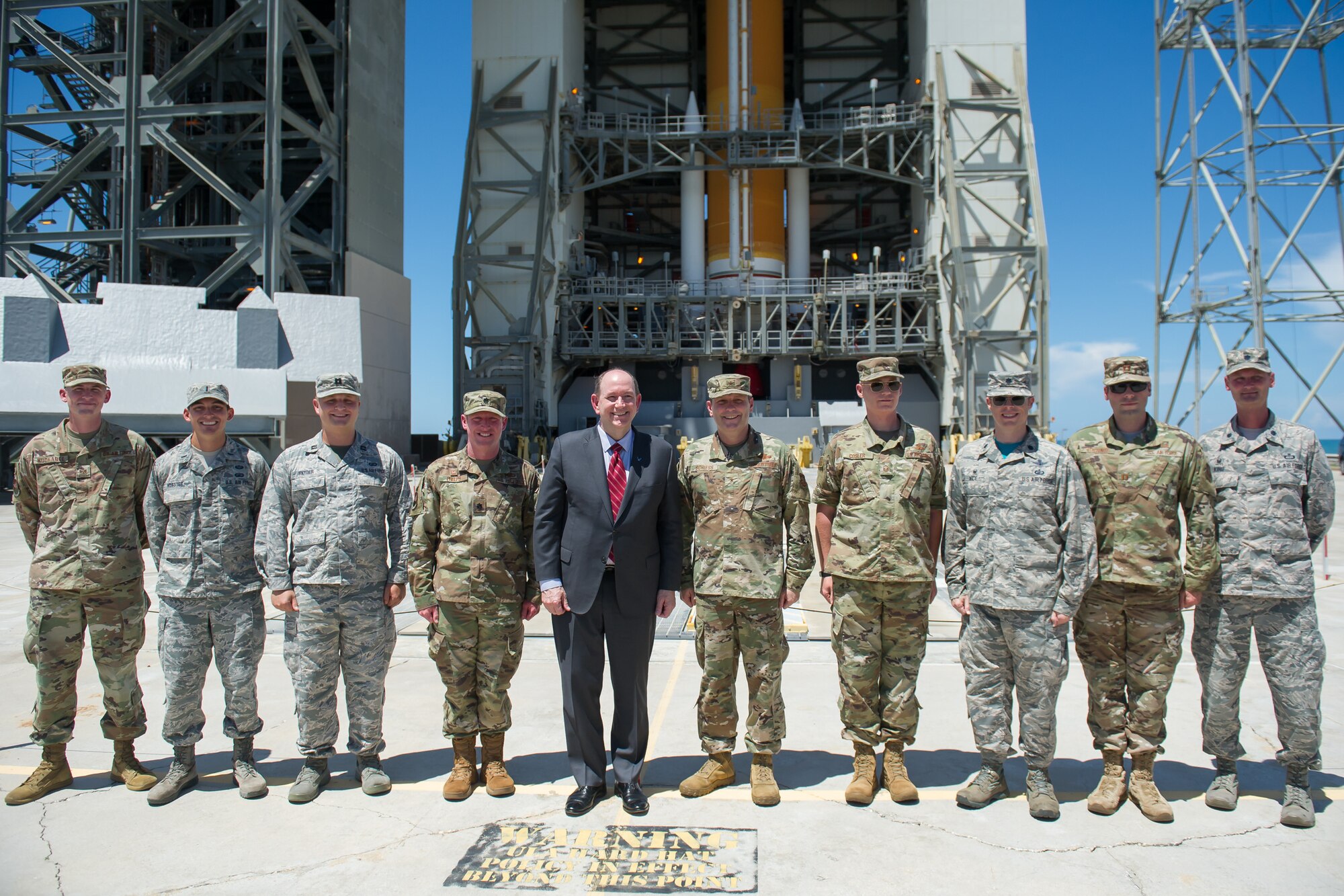 Acting Secretary of the Air Force Matthew Donovan poses for a photo in front of United Launch Alliance’s Delta IV rocket with Brig. Gen. Doug Schiess, 45th Space Wing commander, and Airmen from the 45th Operations Group on July 19, 2019, at Space Launch Complex-37 on Cape Canaveral Air Force Station, Fla. Donovan visited the 45th Space Wing to become more familiar with space launch operations and celebrate the 50th anniversary of NASA’s Apollo 11 mission. (U.S. Air Force photo by Jared Trimarchi)
