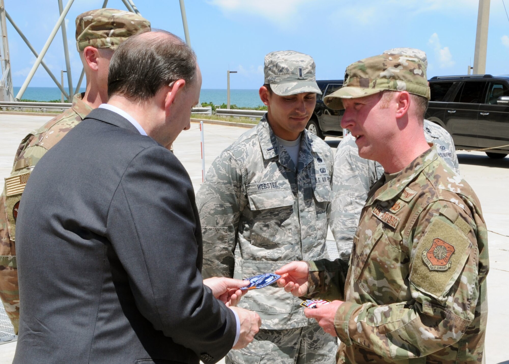 Acting Secretary of the Air Force Matthew Donovan receives a patch from an Airman from the 45th Operations Group on July 19, 2019, at Cape Canaveral Air Force Station, Fla. Donovan met with Airmen from the 45th Space Wing in front of United Launch Alliance’s Delta IV rocket at Space Launch Complex-37 to learn more about how they contribute to the space launch mission. (U.S. Air Force photo by Airman 1st Class Dalton Williams)
