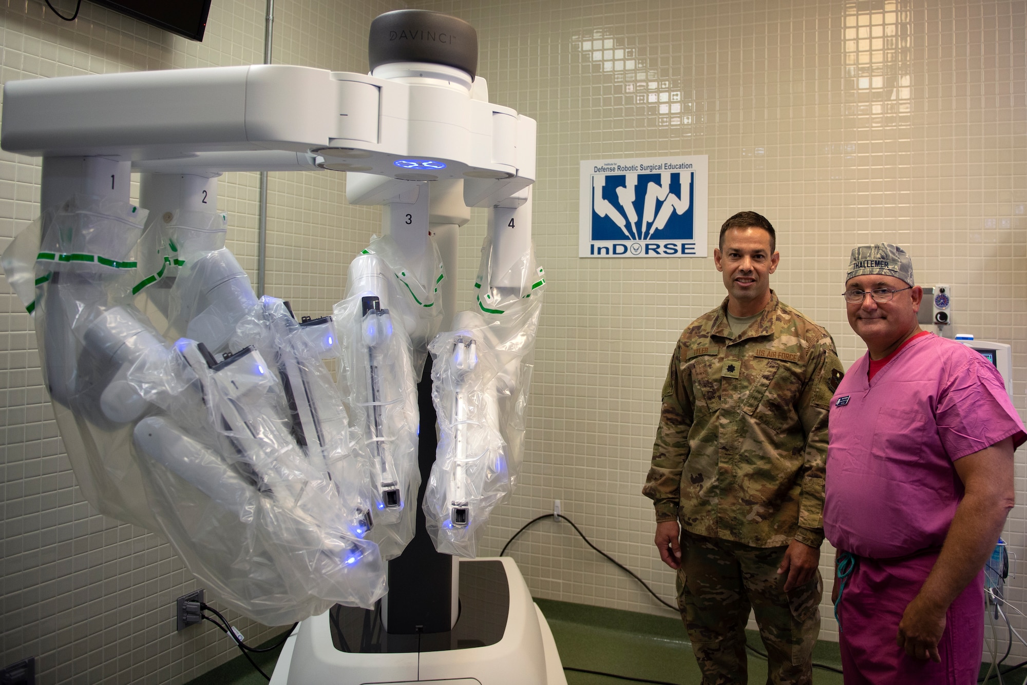 U.S. Air Force Lt. Col. Josh Tyler, 81st Surgical Operations Squadron Institute for Defense Robotic Surgery Education director, and Maj. Scott Thallemer, 81st MSGS InDORSE robot coordinator, pose for a photo in the Clinical Research Lab on Keesler Air Force Base, Mississippi, June 27, 2019. InDORSE is a program created by Tyler and Thallemer to provide surgeons with training on the DaVinci Xi surgical robot. Keesler AFB was the first hospital to have the DaVinci Xi in the Air Force. (U.S. Air Force photo by Airman 1st Class Kimberly L. Mueller)