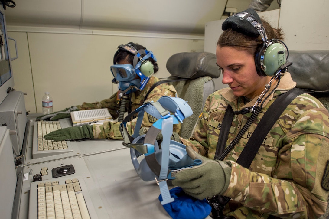 Army airborne technician systems specialist (right) and deputy mission control commander, both with Army JSTARS, participate in emergency drill onboard E-8C Joint STARS during routine training mission at Robins Air Force Base, Georgia, March 21, 2019 (U.S. Air National Guard/Nancy Goldberger)