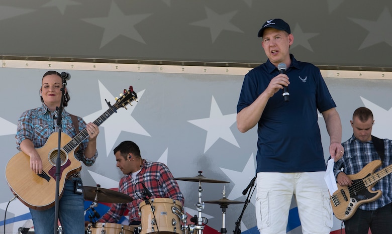 Col. James Smith, 50th Space Wing commander, gives opening remarks for the annual Summer Slam base picnic at Schriever Air Force Base, Colorado, July 19, 2019. The Summer Slam consisted of events ranging from face painting to BMX shows. (U.S. Air Force photo by Airman 1st Class Jonathan Whitely)