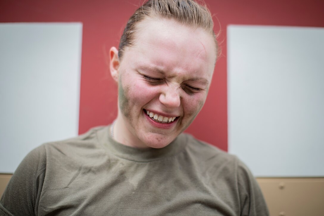 U.S. Army Specialist Emma Archut, 328th Military Police Company, winces in pain from shoulder spasms after completing timed 12-mile ruck march during New Jersey National Guard’s Best Warrior Competition, April 11, 2019 (U.S. Air National Guard/Matt Hecht)