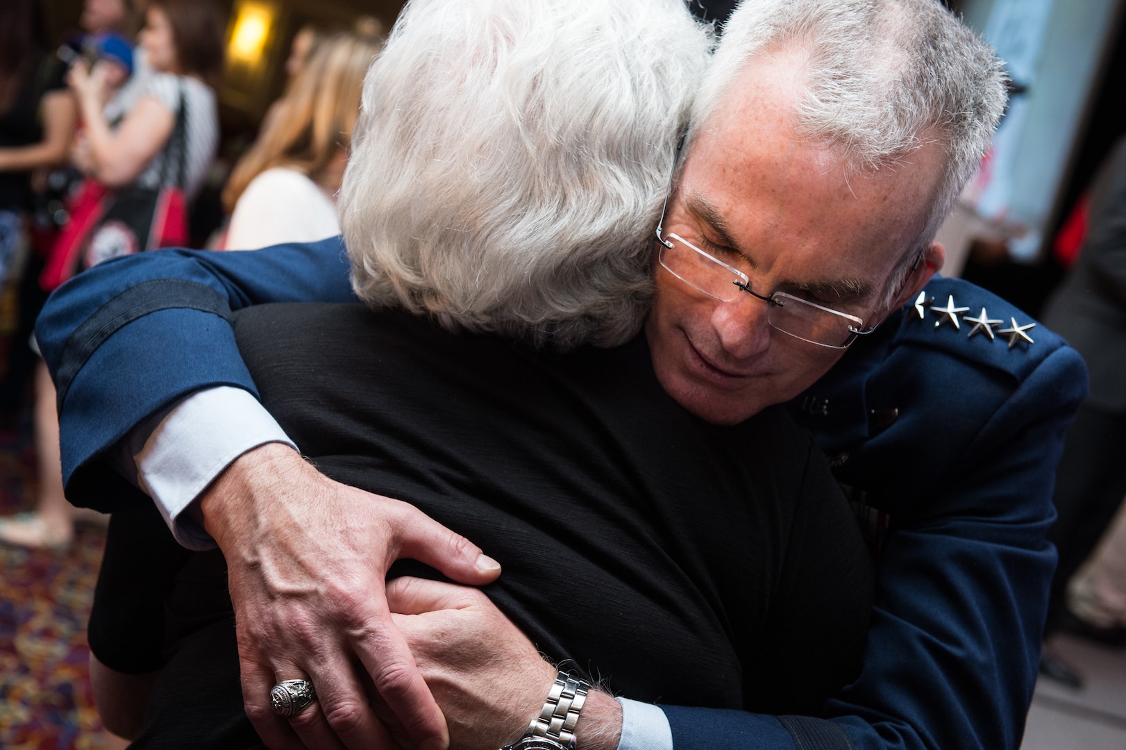 Air Force General Paul J. Selva embraces surviving family member after Tragedy Assistance Program for Survivors Grand Banquet at 23rd TAPS National Military Survivor Seminar and Good Grief Camp in Arlington, Virginia, May 27, 2017 (DOD/James K. McCann)