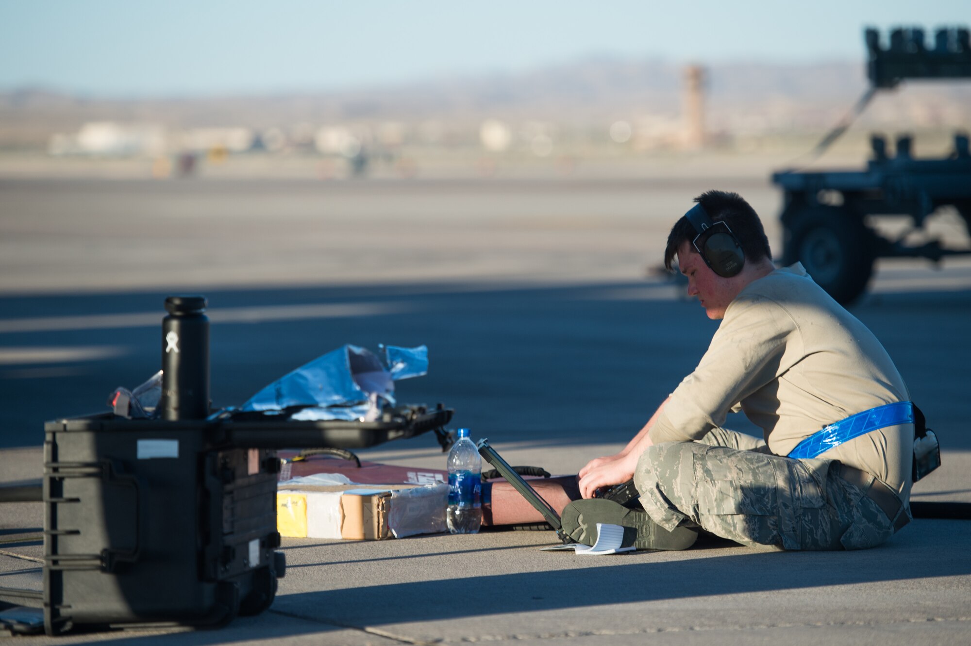 U.S. Air Force Airman 1st Class Zachary Perry, 94th Aircraft Maintenance Unit integrated avionics journeyman, runs checks after performing maintenance on an F-22 Raptor at Nellis Air Force Base, Nevada, July 16, 2019.