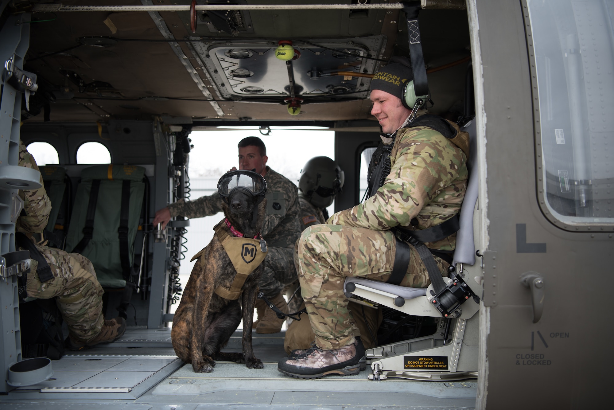 Tech. Sgt. Rudy Parsons, a pararescueman with the Kentucky Air National Guard’s 123rd Special Tactics Squadron, and his search and rescue dog, Callie, ride in a UH-60 Black Hawk helicopter as part of Callie’s familiarization training at the Boone National Guard Center in Frankfort, Ky., Nov. 29, 2018. Callie is currently the only search and rescue dog in the Department of Defense. (U.S. Air National Guard photo by Staff Sgt. Joshua Horton)