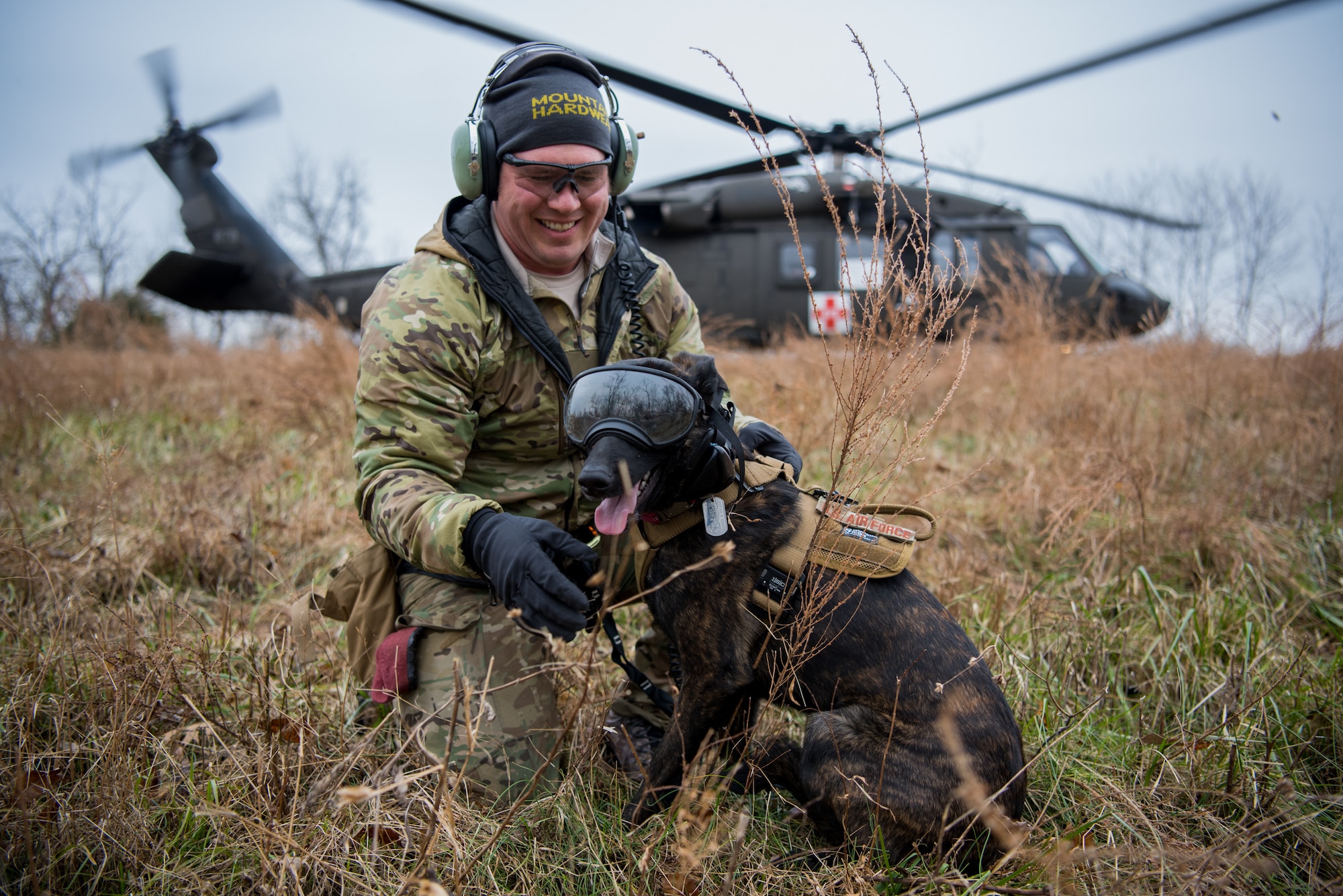 Tech. Sgt. Rudy Parsons, a pararescueman with the Kentucky Air National Guard’s 123rd Special Tactics Squadron, and his search and rescue dog, Callie, exit a UH-60 Black Hawk helicopter as part of Callie’s familiarization training at the Boone National Guard Center in Frankfort, Ky., Nov. 29, 2018. Callie is currently the only search and rescue dog in the Department of Defense. (U.S. Air National Guard photo by Staff Sgt. Joshua Horton)