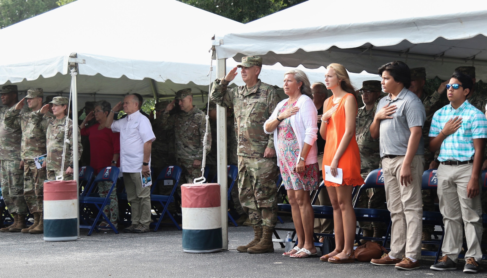 Lt. Gen. Laura J. Richardson, U.S. Army North Commanding General, Maj. Gen. David P. Glaser, the new U.S. Army North Deputy Commanding General-Operations and guests stand and honor the nation's colors during the National Anthem during a ceremony at the Quadrangle at Joint Base San Antonio-Fort Sam Houston July 23.