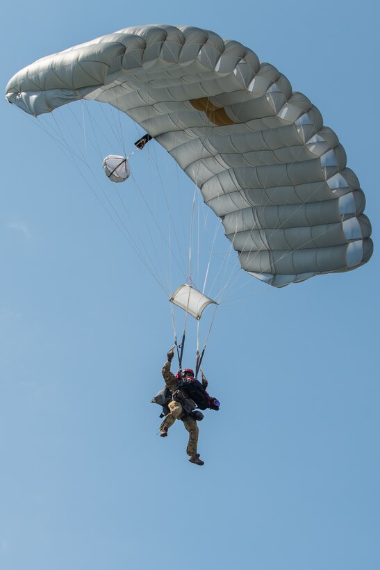 Master Sgt. Rudy Parsons, a pararescueman with the Kentucky Air National Guard’s 123rd Special Tactics Squadron, and Callie, his search and rescue dog, complete a parachute insertion into Volk, Wis., July 16, 2019, as part of Patriot North, an annual domestic operations exercise designed to provide natural disaster-response training. Callie is currently the only search and rescue dog in the Department of Defense. (U.S. Air National Guard photo by Staff Sgt. Joshua Horton)