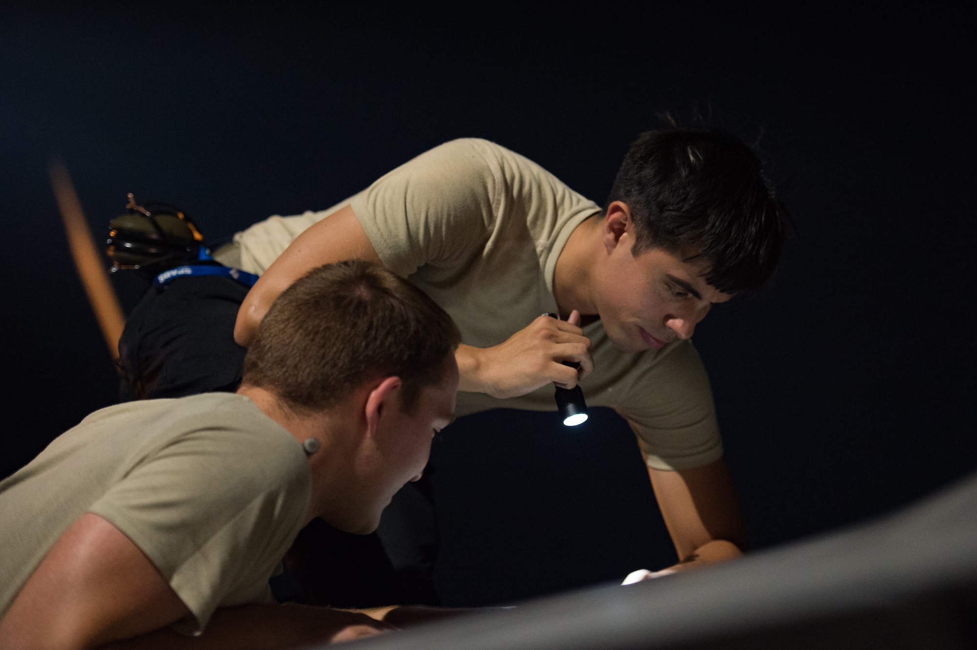 U.S. Air Force integrated avionics specialists from the 94th Aircraft Maintenance Unit perform maintenance on an F-22 Raptor at Nellis Air Force Base, Nevada, July 22, 2019.