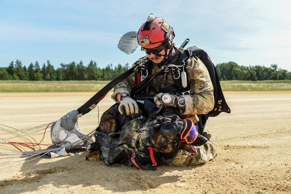 Master Sgt. Rudy Parsons, a pararescueman with the Kentucky Air National Guard’s 123rd Special Tactics Squadron, and Callie, his search and rescue dog, land at Volk Field, Wis., July 17, 2019, as part of a domestic operations exercise. Callie is currently the only search and rescue dog in the Department of Defense. (U.S. Air National Guard photo by Staff Sgt. Joshua Horton)