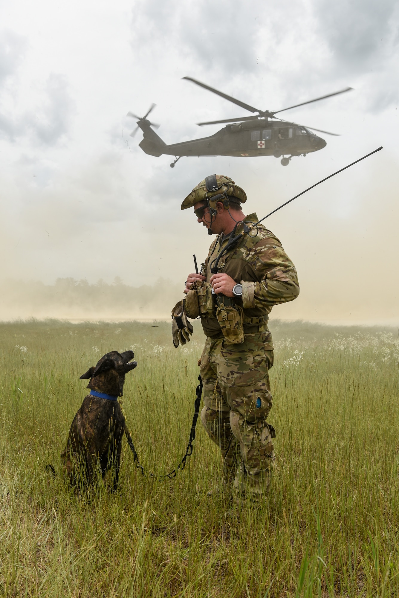 Master Sgt. Rudy Parsons, a pararescueman with the Kentucky Air National Guard’s 123rd Special Tactics Squadron, and Callie, his search and rescue dog, participate in Patriot North, an annual domestic operations exercise designed to provide natural disaster-response training at Volk Field, Wis., July 17, 2019. Callie is currently the only search and rescue dog in the Department of Defense. (U.S. Air National Guard photo by Staff Sgt. Joshua Horton)