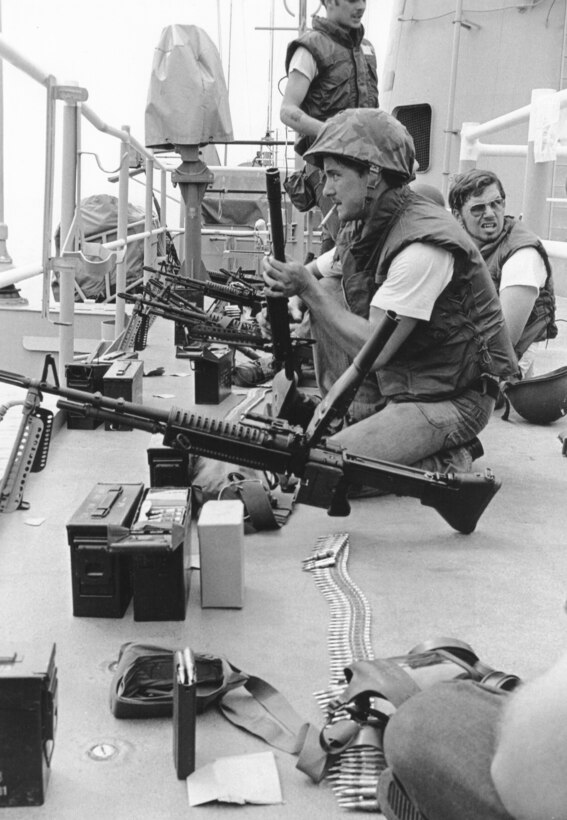 Marines with M-60 machine guns on deck of merchant ship SS Mayaguez after boarding it and finding it empty (U.S. Marine Corps)