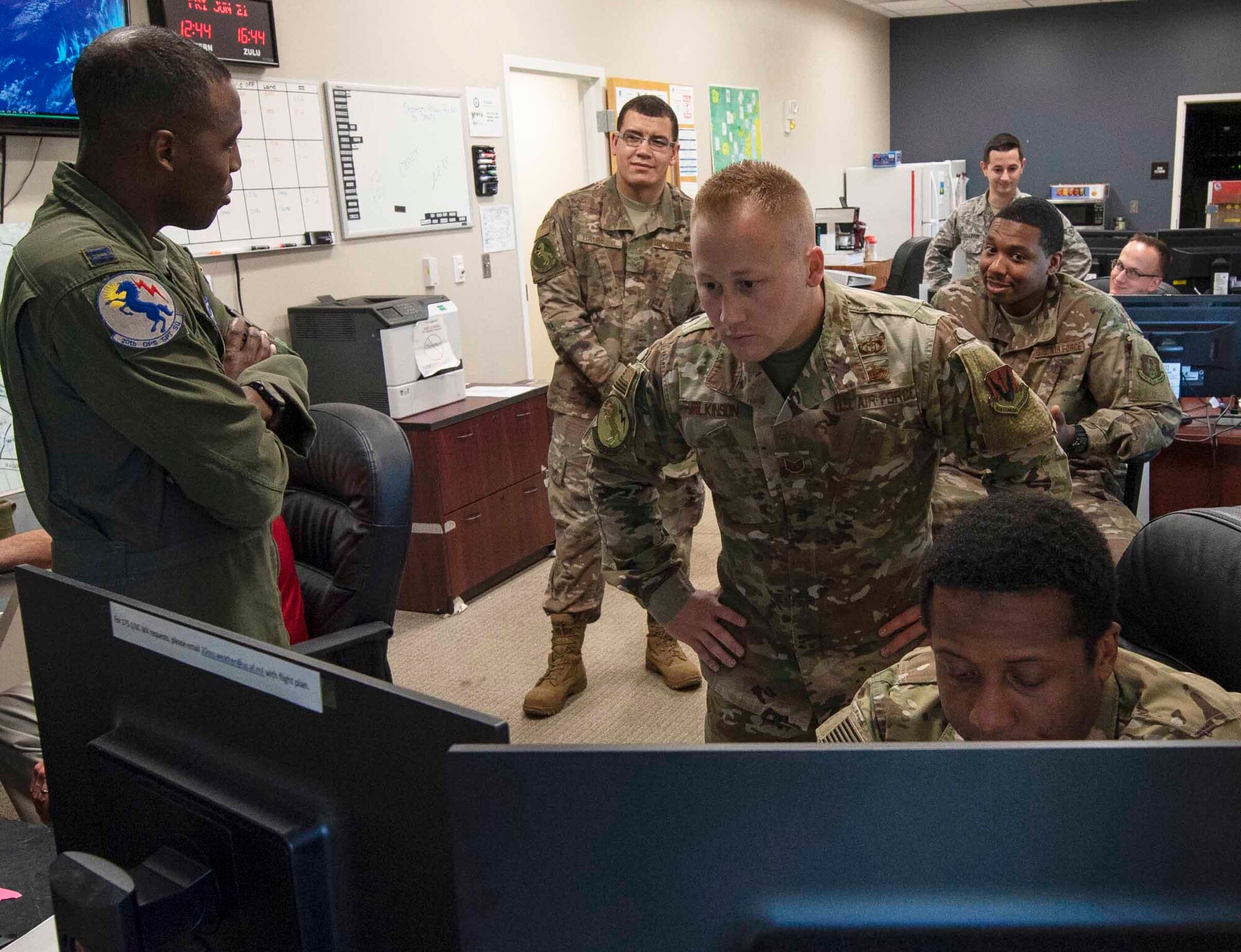 U.S. Airmen assigned to the 20th Operations Support Squadron weather flight office work together to monitor local weather at Shaw Air Force Base, South Carolina, June 21, 2019.