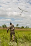 Cpl. Matthew Mena, field artillery tactical data system specialist assigned to Charlie Battery, 1st Battalion, 258th Field Artillery Regiment, launches a RQ-11B Raven small unmanned aircraft system during the unit's annual training at Fort Drum, N.Y., July 21, 2019. During the training, Soldiers across the 27th Infantry Brigade Combat Team were able to log flight time on the Raven to keep their operator certifications current.