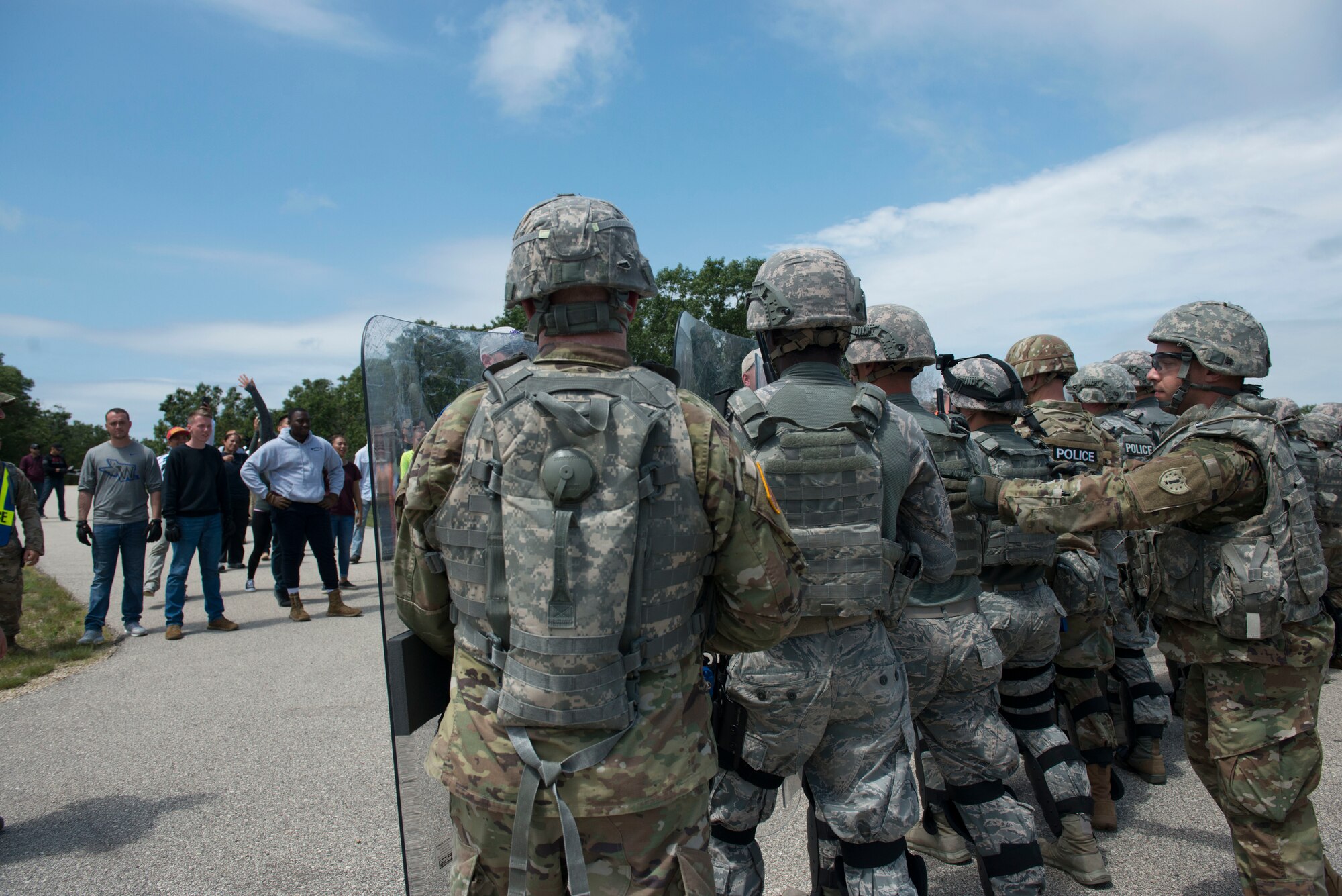 National Guardsmen assigned to the New Hampshire Army National Guard and the New Hampshire and Connecticut  Air National Guard face violent protesters in a simulated public disturbance during the PATRIOT North 19 domestic operations exercise, July 18, 2019 at Fort McCoy, WI. PATRIOT North is an annual domestic operations exercise, which tests the ability of the National Guard to work together with local, state and federal entities to respond to emergencies. (U.S. Air National Guard photo by Tech. Sgt. Tamara R. Dabney)