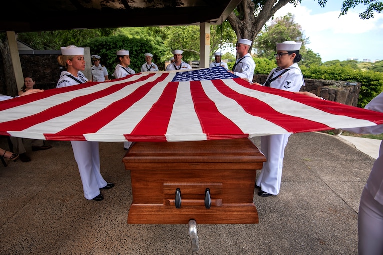 Sailors conduct a funeral in Honolulu for Navy Seaman 1st Class Millard Burk, who was killed in World War II. The Defense POW/MIA Accounting Agency recently identified his remains.