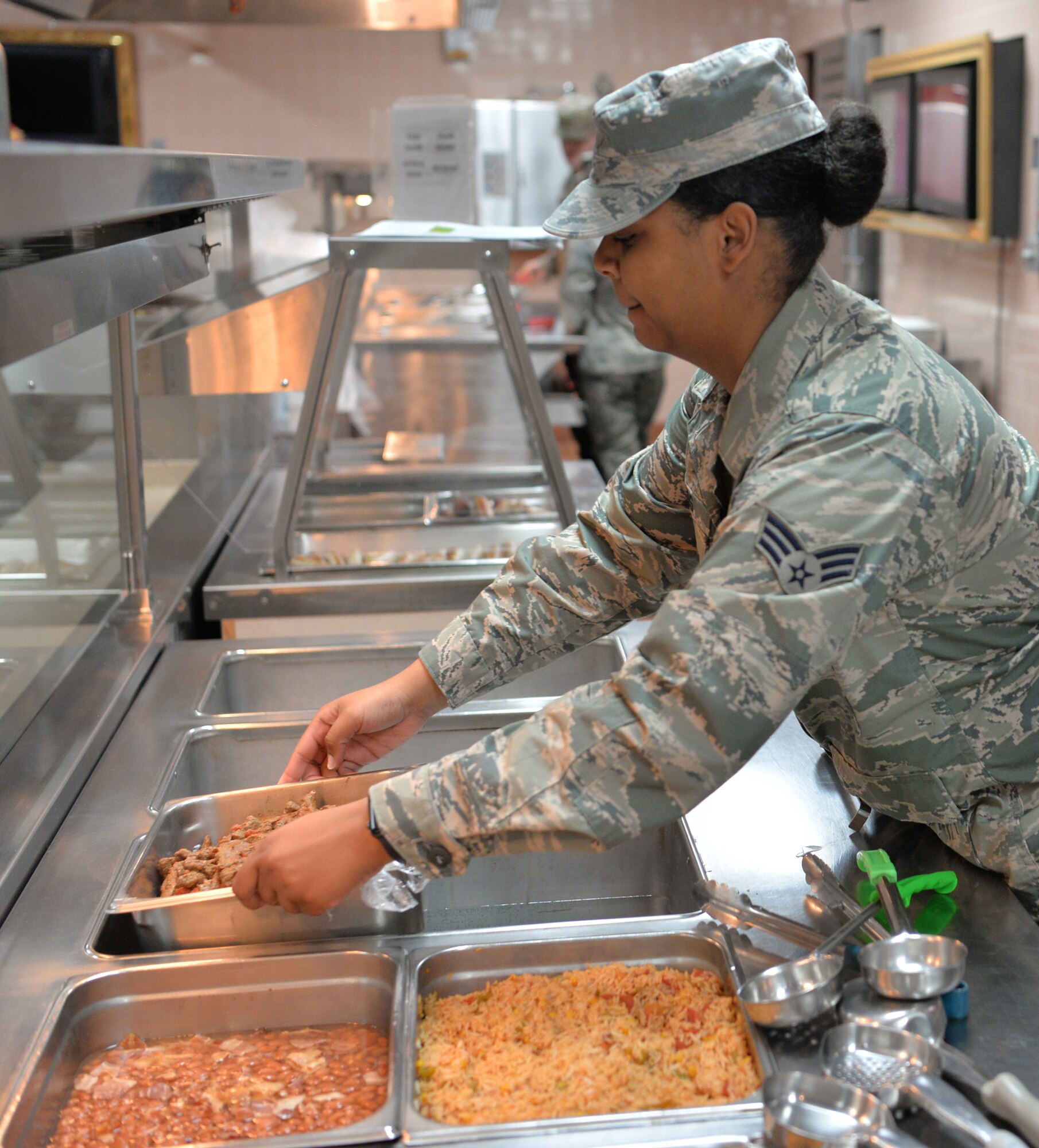 Senior Airman Tati-Anna Thomas, 926th Force Support Squadron food service journeyman, prepares lunch for service members during Red Flag 19-3 at Nellis Air Force Base, Nev., July 18, 2019. Red Flag is a combat training exercise designed to expose pilots to their first 10 “combat missions," allowing them to be more confident and effective in real-world combat. (U.S. Air Force photo by Tech. Sgt. Bryan Magee)