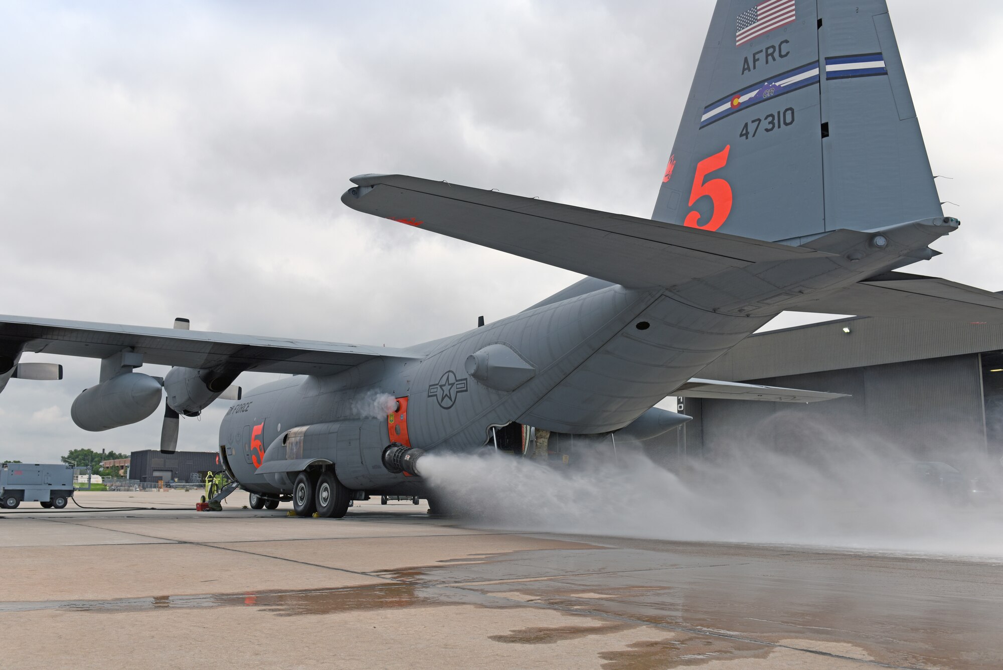 A 302nd Airlift Wing Modular Airborne Fire Fighting System equipped-C-130 Hercules aircraft performs a system test at Peterson Air Force Base, Colorado, July 22, 2019