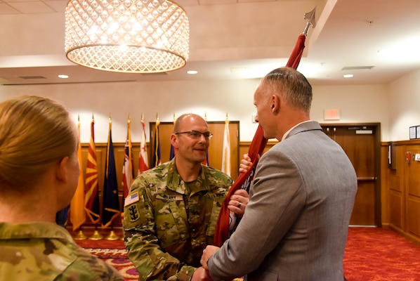 Col. Christopher Crary, U.S. Army Corps of Engineers (USACE), Far East District (FED) commander, passes the district colors to Richard Byrd, deputy district engineer, during a change of command ceremony held at River Bend Golf Course, Camp Humphreys, South Korea, July 24.