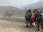 Twenty-six people and two dogs were evacuated overnight from an Alaskan hunting and recreation lodge after a rapid-spreading wildfire threatened the area, approximately 125 air miles from Anchorage, July 23, 2019. An HH-60 Pave Hawk helicopter from the Alaska Air National Guard’s 210th Rescue Squadron and a CH-47 Chinook helicopter from the Alaska Army National Guard’s 1st Battalion, 207th Aviation Regiment, evacuated the individuals and transported them to safety at JBER. This was the first rescue mission accomplished by the Chinooks since they joined the 1-207th last December.