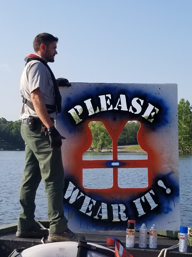 Park Ranger JD Tucker waits patiently as he, and fellow rangers, prepare to paint water safety messages on bridge piers around Rough River Lake.