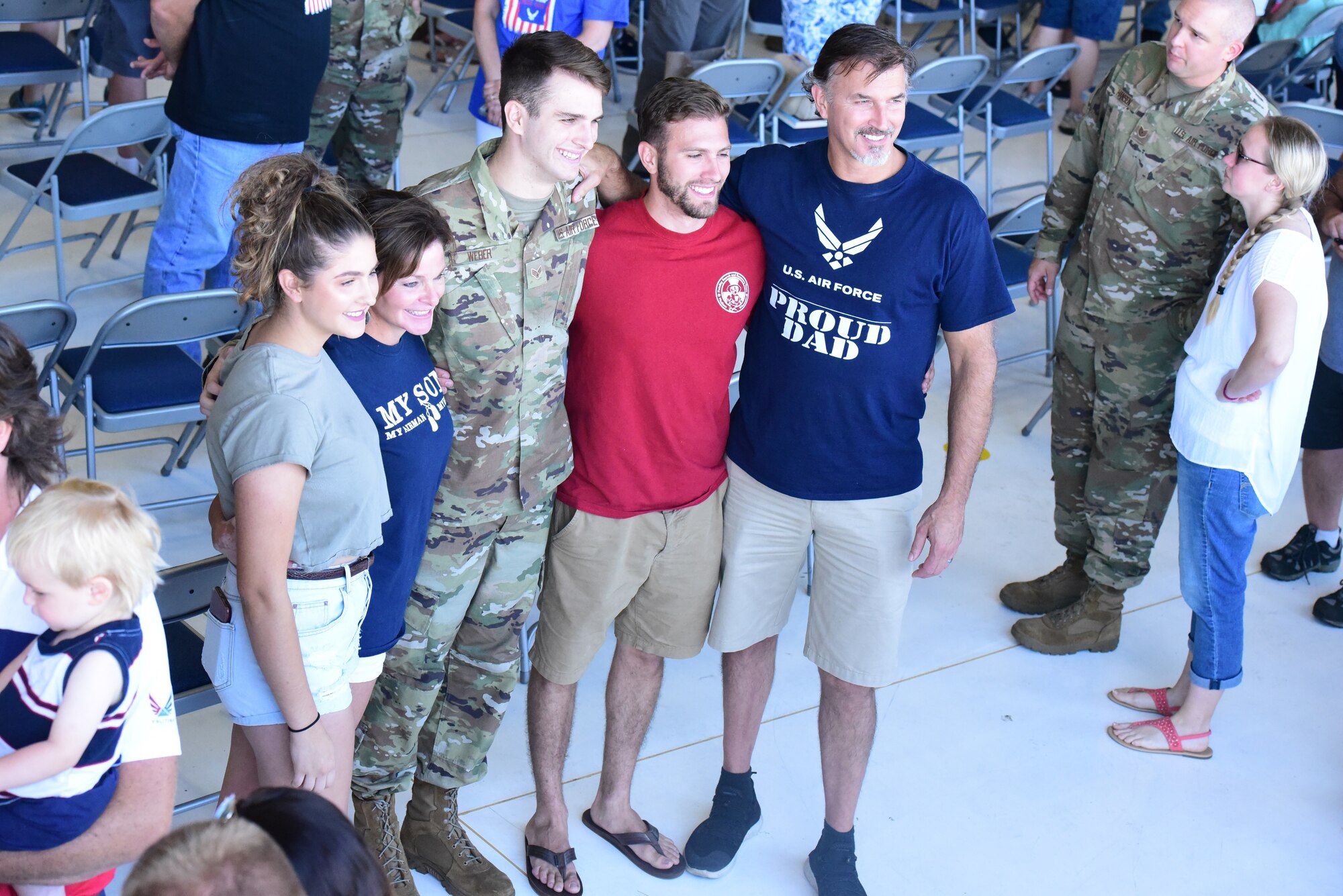 Senior Airman Nicholas Weber poses for a family photo at a send off ceremony held for deploying members of the 115th Figher Wing at Truax Field, Madison, Wis. on July 21, 2019.  The 115th Fighter Wing deployed approximately 300 personnel and a number of aircraft to Afghanistan in support of Operation Freedom Sentinel and NATO's Resolute Support. (U.S. Air National Guard photo by Staff Sgt. Kyle Russell)