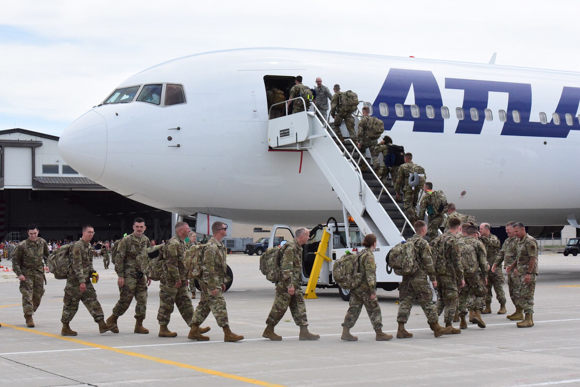 Airmen from the 115th Fighter Wing board a Boeing 767 aircraft after a send off ceremony held at Truax Field, Madison, Wis. on July 21, 2019.  The 115th Fighter Wing deployed approximately 300 personnel and a number of aircraft to Afghanistan in support of Operation Freedom Sentinel and NATO's Resolute Support. (U.S. Air National Guard photo by Staff Sgt. Kyle Russell)