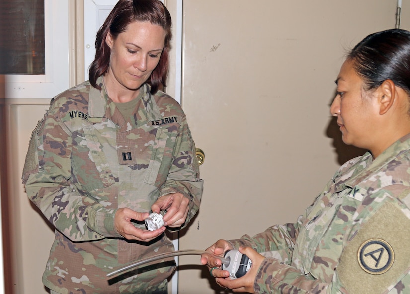 Capt. Jessica Myers, 3d Medical Command Deployment Support - Forward, conducts an air quality assessment with Sgt. 1st Class Nichaya Srisark, Area Support Group - Qatar, at Camp As Sayliyah, Qatar, July 19, 2019.