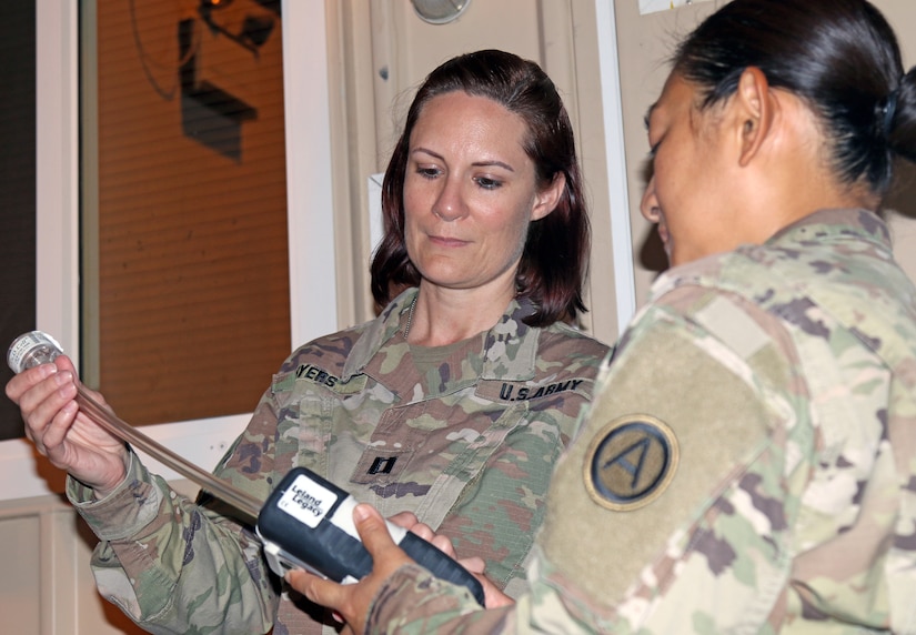 Capt. Jessica Myers, 3d Medical Command Deployment Support - Forward,  conducts an air quality assessment with Sgt. 1st Class Nichaya Srisark, Area Support Group - Qatar, at Camp As Sayliyah, Qatar, July 19, 2019.