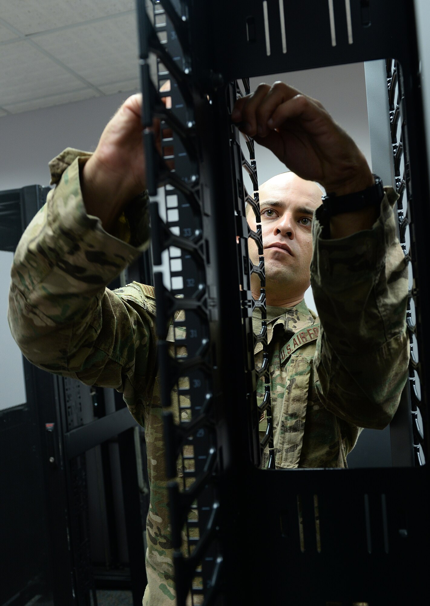 Tech. Sgt. Nick Doage, 217th Engineering and Installation Squadron quality assurance, assembles a hard drive rack July 10, 2019, inside the Martin Bomber building at Offutt Air Force Base, Nebraska.Air National Guard members from the 217th and 210th Engineering Installation Squadrons out of Illinois and Minnesota traveled here to aid the 55th Communications Squadron in laying new fiber-cabling for the 97th Intelligence Support Squadron and other various squadrons.