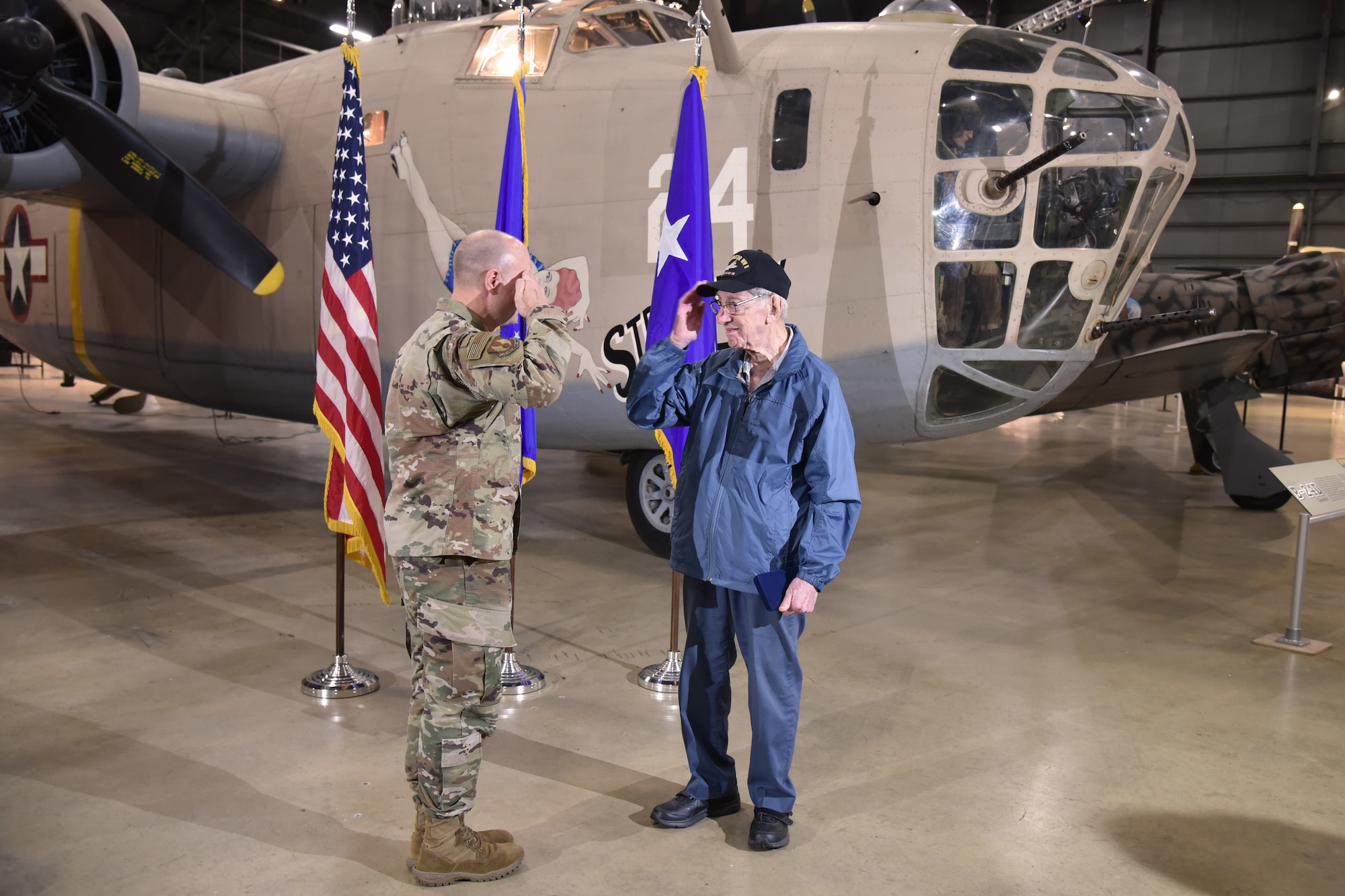 Maj. Gen. Carl Schaefer, Air Force Materiel Command deputy commander, renders a salute to 93-year-old World War II veteran 1st Lt. Joseph Kollenberg after a ceremony at the National Museum of the United States Air Force, July 24. Schaefer presented Kollenberg with the  Distinguished Flying Cross, the Air Medal with three Oak Leaf Clusters, and the European, African, and Middle Eastern campaign service medals to replace those misplaced in the 70 years since the veteran left active duty service. (Air Force photo/Ken LaRock)