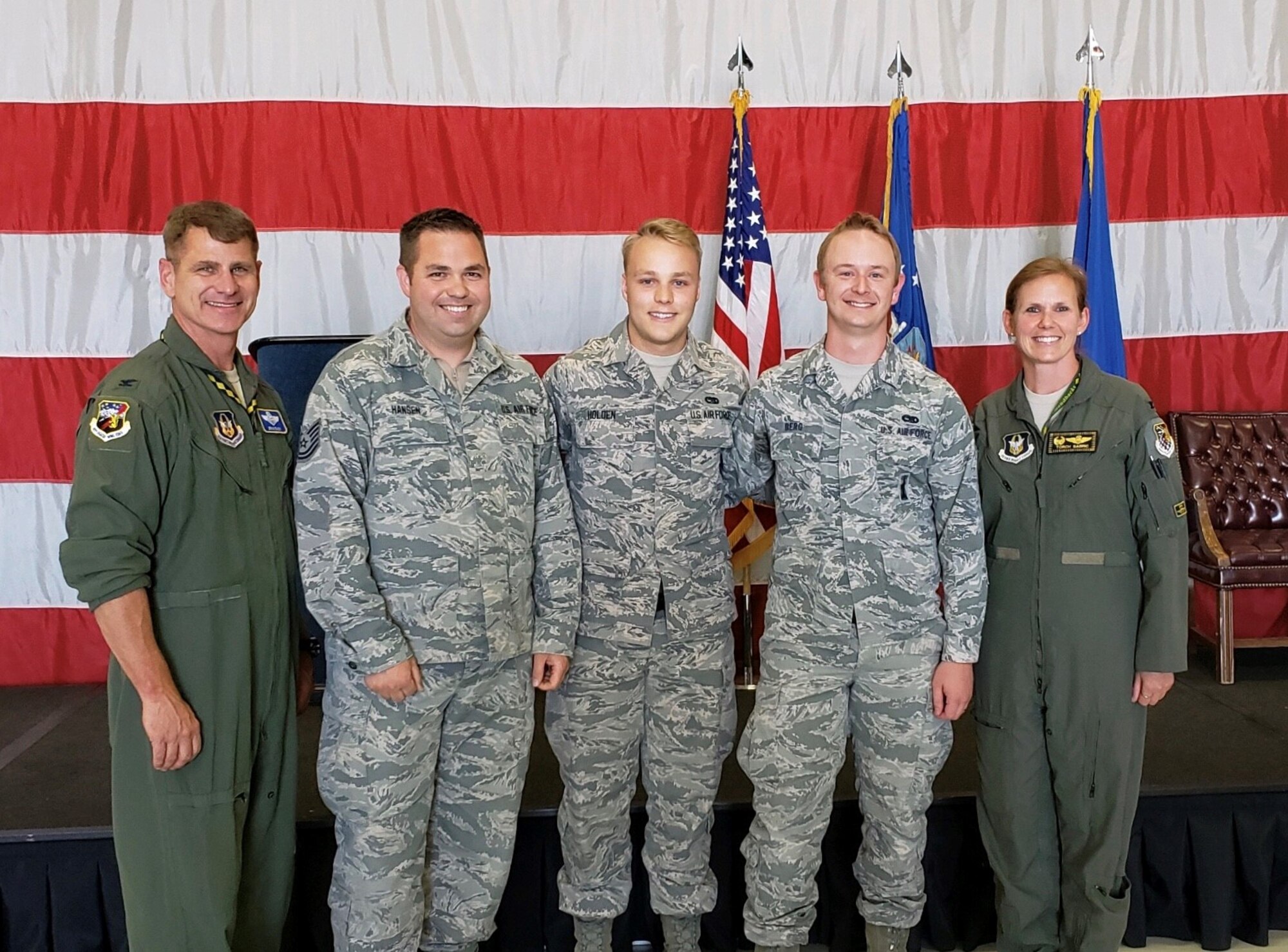 Col. Gina Sabric (right), 419th Fighter Wing commander, and Col. Brian Silkey (left), the wing's vice commander, pose beside the winner's of the quarterly F-35 weapons load competition at Hill Air Force Base