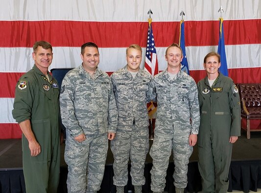 Col. Gina Sabric (right), 419th Fighter Wing commander, and Col. Brian Silkey (left), the wing's vice commander, pose beside the winner's of the quarterly F-35 weapons load competition at Hill Air Force Base