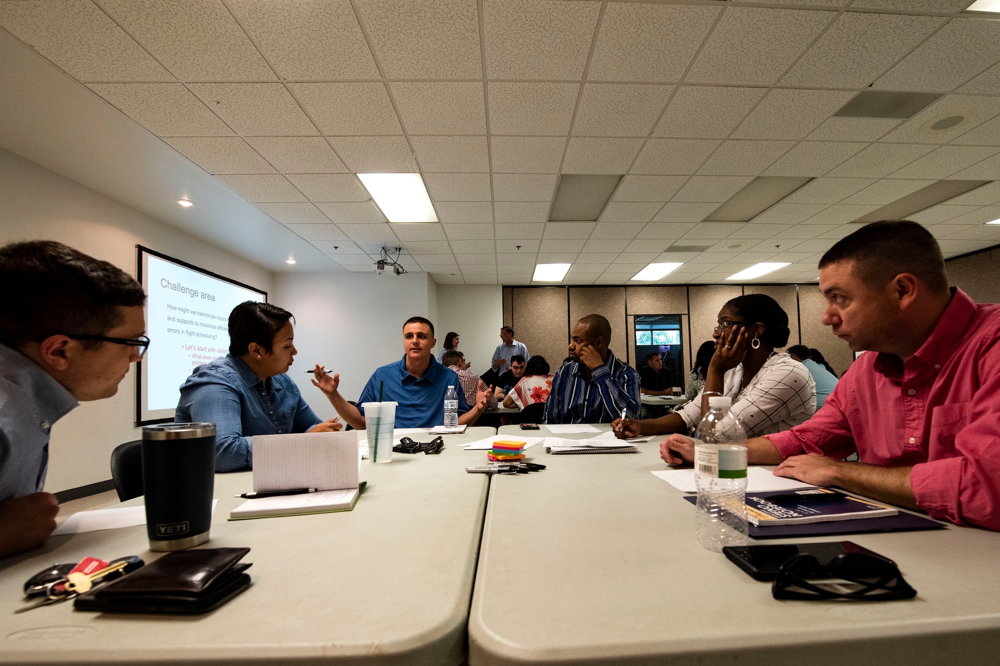 Attendees brainstorm ideas during a National Security Innovation Network “Innovation Bootcamp” course, July 23, 2019, at Moody Air Force Base, Ga. Participants worked together to formulate solutions on how the base can harmonize inputs from operators and support personnel to maximize efficiency and minimize errors in flight scheduling. The training event culminated with participants pitching their ideas for the class to see which one would be the best option. (U.S. Air Force photo by Senior Airman Erick Requadt)