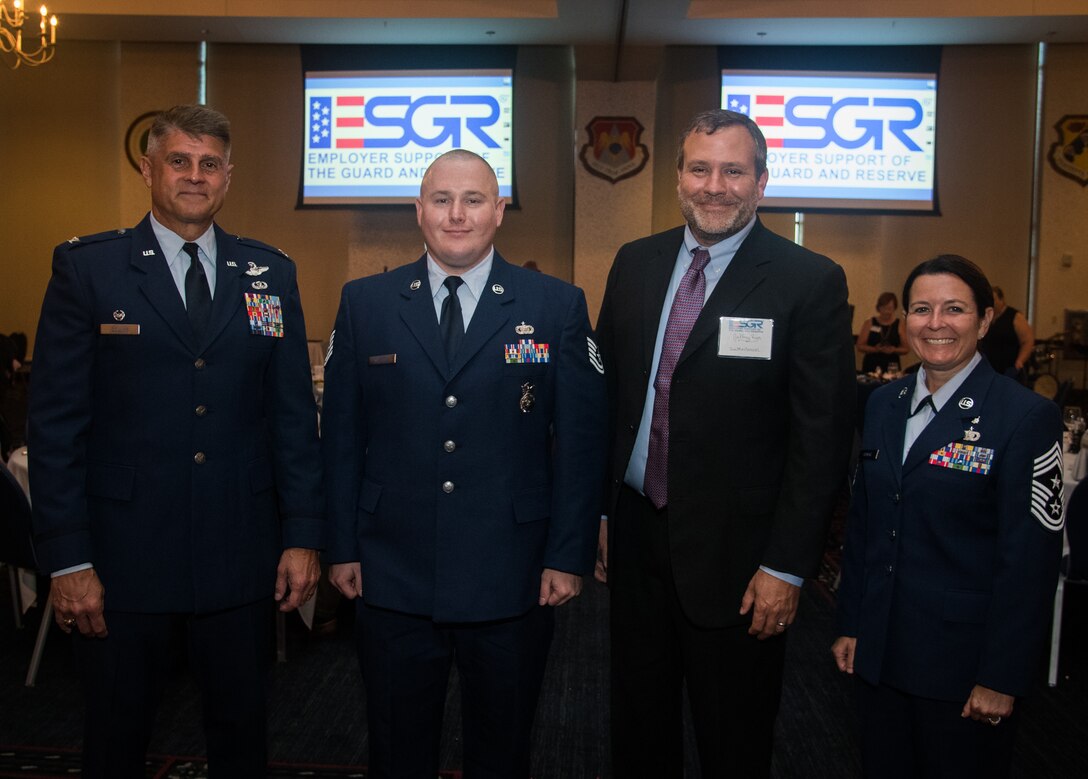 Col. Glenn Collins, commander, 932nd Airlift Wing, left, Tech. Sgt. Christopher Wallace, 932nd Security Forces, Mr. Jeffery Rush, Icon Mechanical and 932nd Command Chief Master Sgt. Barbara Gilmore all pose for a portrait during the Employer Support of the Guard and Reserve award banquet, July 19, 2019, Scott Event Center, Scott Air Force Base, Illinois. (U.S. Air Force photo by Christopher Parr)