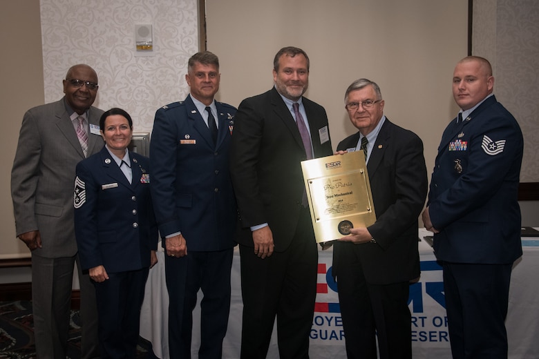 Tech. Sgt. Christopher Wallace, right, stands with ESGR and 932nd Airlift Wing leadership as his civilian employer, Mr. Jeffery Rush, center, accepts the ESGR Pro Patria award for Icon Mechanical during the Employer Support of the Guard and Reserve award banquet, July 19, 2019, Scott Event Center, Scott Air Force Base, Illinois.  The Pro Patria Award is the highest level of ESGR awards given to employers that demonstrate exceptional support of employees of the National Guard and Reserve.(U.S. Air Force photo by Christopher Parr)