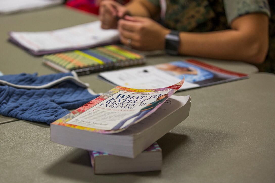 Volunteers with the Navy-Marine Corps Relief Society (NMCRS) conduct the Budget for Baby Workshop at Marine Corps Air Station Yuma, Ariz., July 9, 2019. The NMCRS helps service members and their families prepare financially for their baby's arrival. (U.S. Marine Corps photo by Cpl. Sabrina Candiaflores)