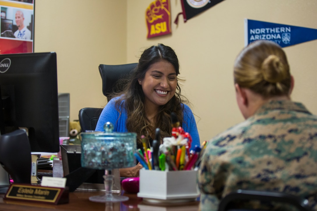 Estela Marin, an Arizona Western College representative for military members aboard Marine Corps Air Station (MCAS) Yuma, Ariz., gives assistance to a Marine at the MCAS Yuma Education Center, July 8, 2019. (U.S. Marine Corps photo by Cpl. Sabrina Candiaflores)