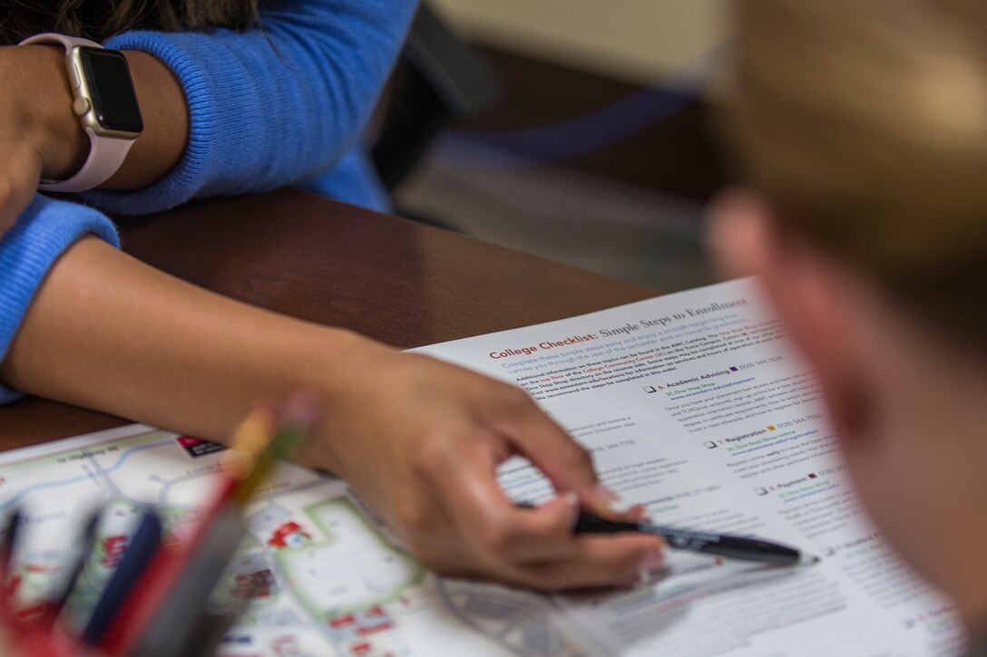 Estela Marin, an Arizona Western College representative for military members aboard Marine Corps Air Station (MCAS) Yuma, Ariz., gives assistance to a Marine at the MCAS Yuma Education Center, July 8, 2019. (U.S. Marine Corps photo by Cpl. Sabrina Candiaflores)