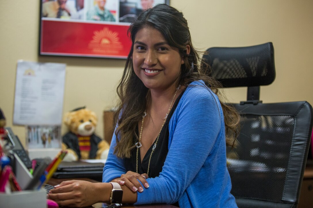 Estela Marin, an Arizona Western College representative for military members aboard Marine Corps Air Station (MCAS) Yuma, Ariz., gives assistance to a Marine at the MCAS Yuma Education Center, July 8, 2019. (U.S. Marine Corps photo by Cpl. Sabrina Candiaflores)