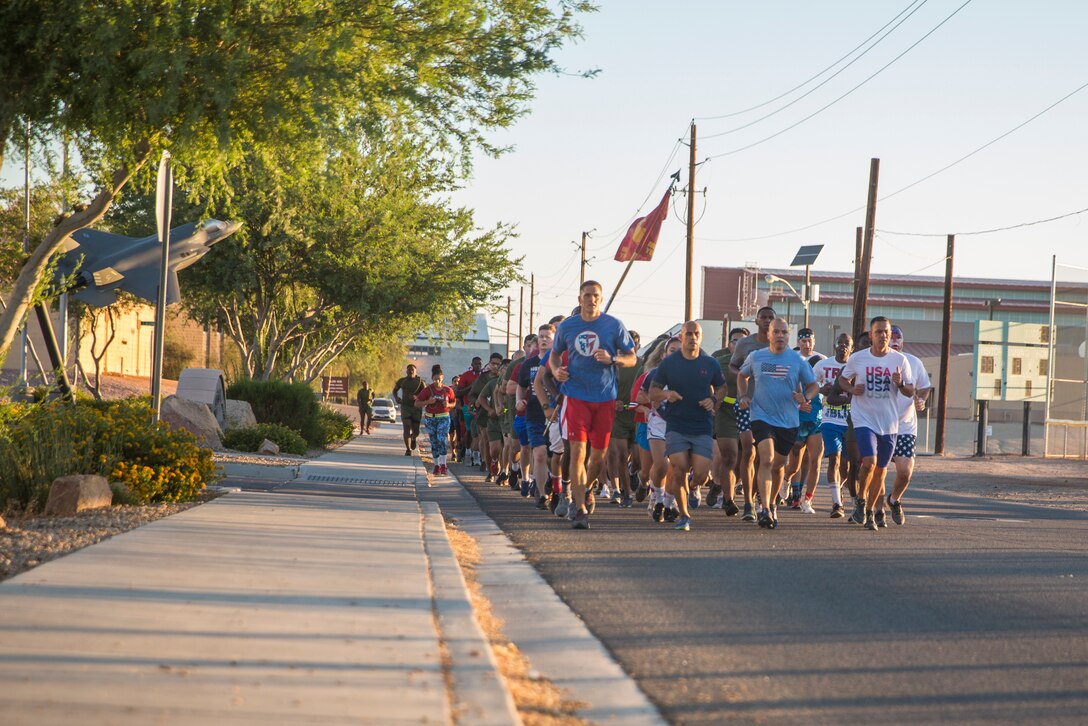 U.S. Marines with Headquarters and Headquarters Squadron (H&HS) participate in an Independence Day Motivational Run at Marine Corps Air Station Yuma, Ariz., July 3, 2019. After the run, Marines throughout the squadron were awarded and recognized for various accomplishments. (U.S. Marine Corps photo by Cpl. Sabrina Candiaflores)