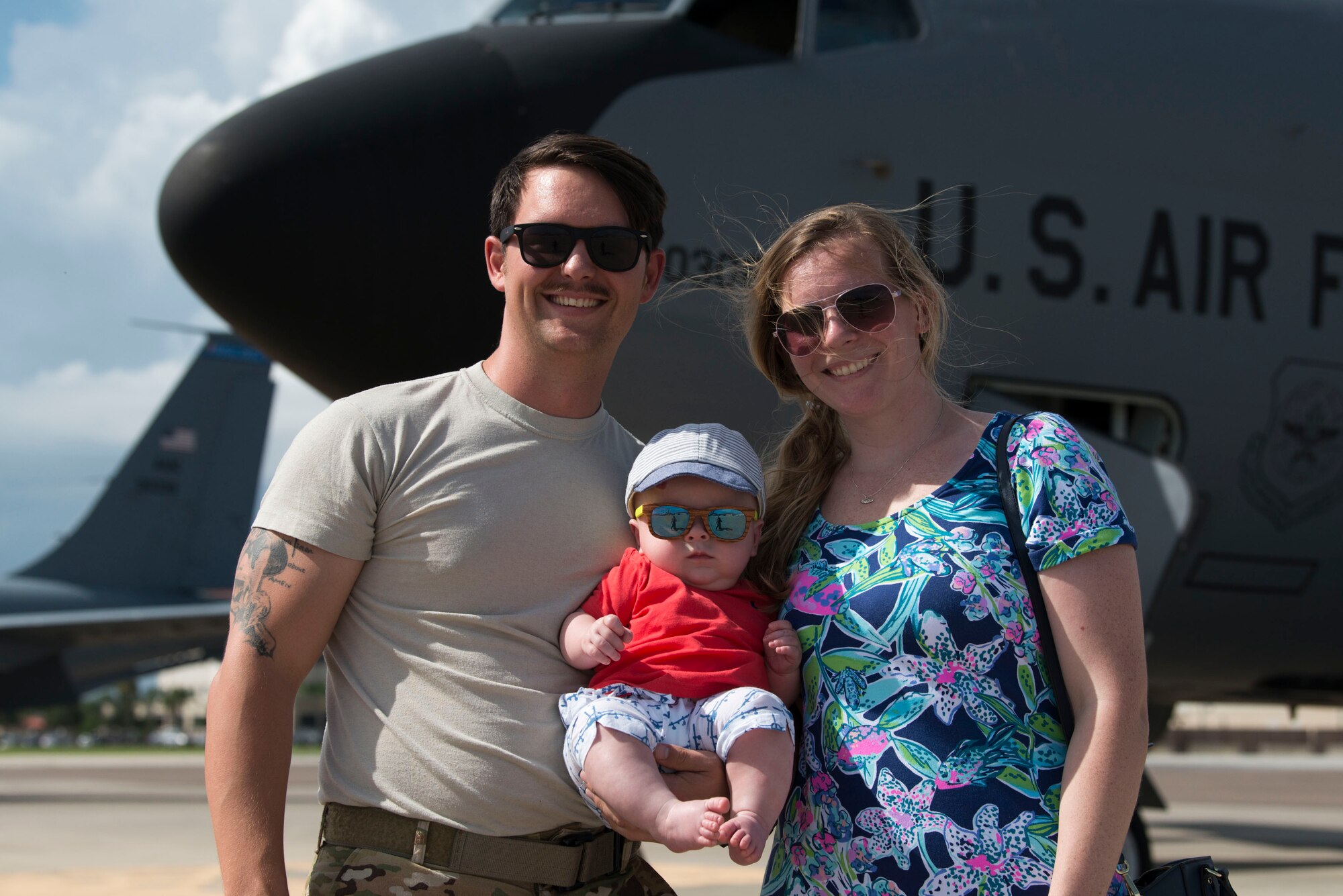 U.S. Air Force Capt. Scott Cronin, a pilot assigned to the 50th Air Refueling Squadron, poses with his wife Courtney and their child Julian, after returning from his deployment, MacDill Air Force Base Fla., July 22, 2019.