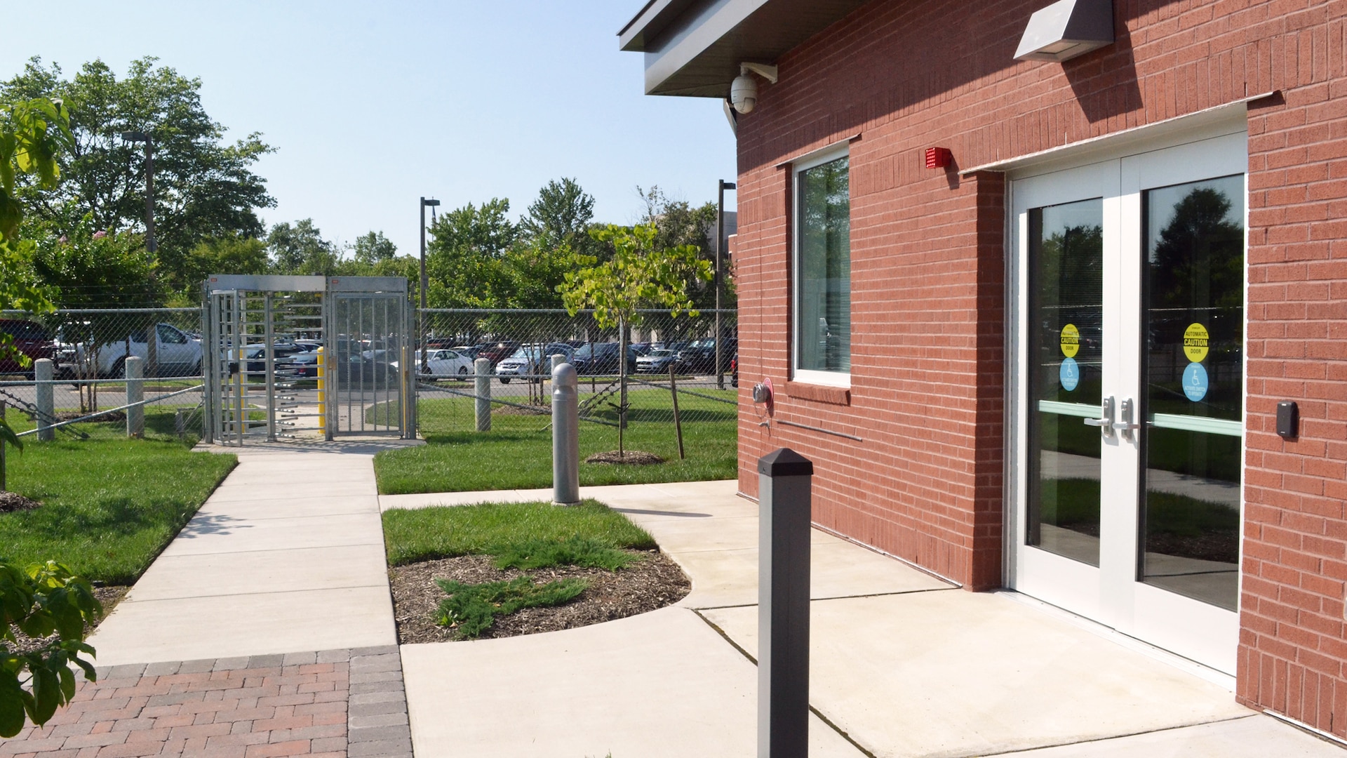 Outside entrance of the Visitor Control Center and the walk path to the turnstile to access the complex.